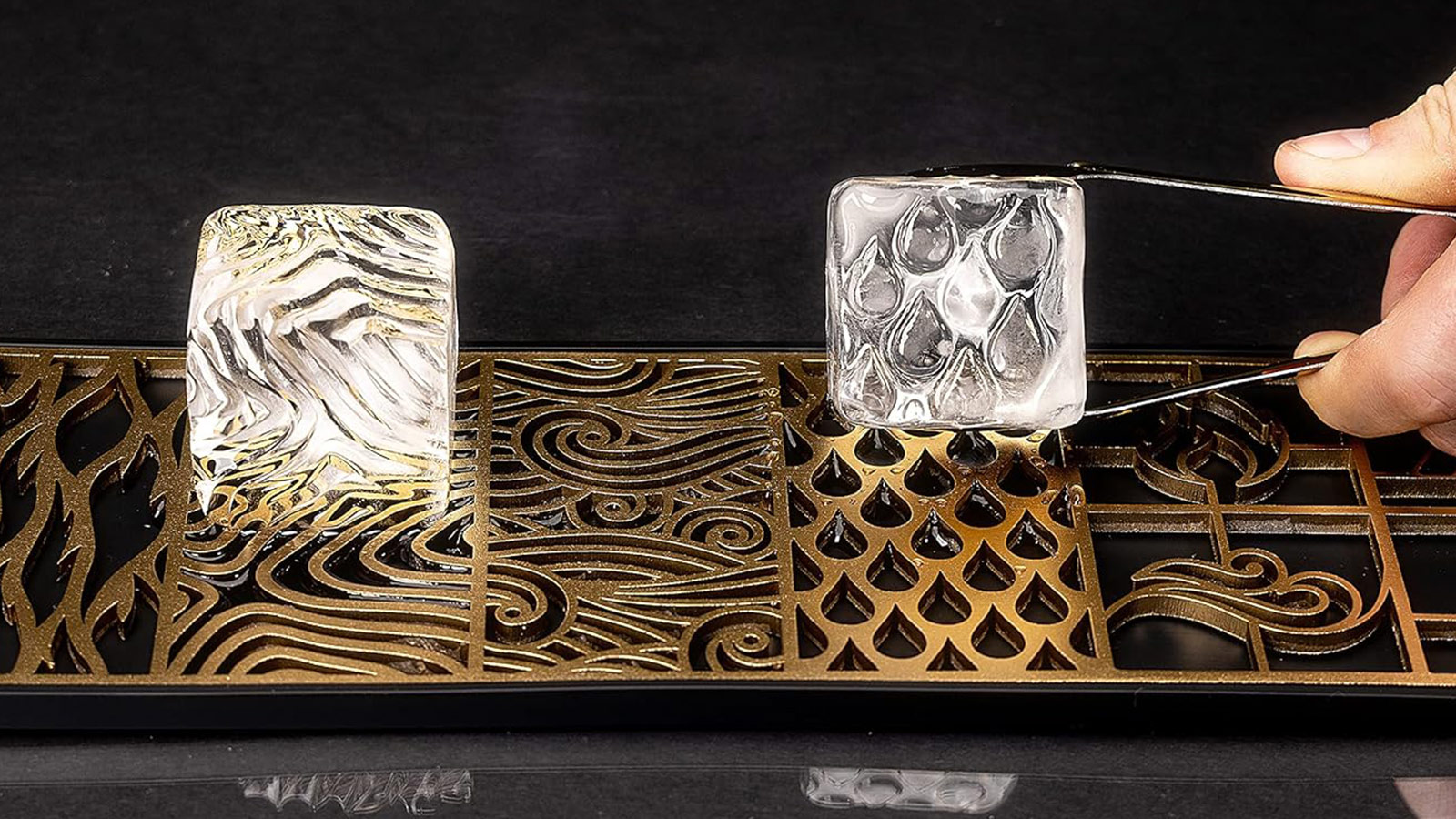 Patterned clear-ice press creating textured whiskey ice cubes — a creative bar tool for the Best Whiskey Gifts for Men 2025.