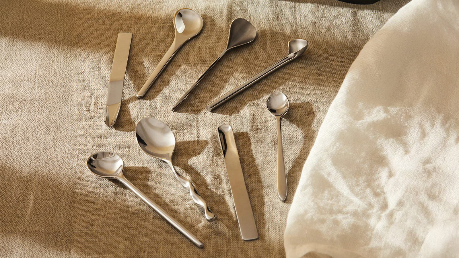 Stainless steel Alessi coffee spoon set arranged on a linen cloth for Best Coffee Gifts for 2025.