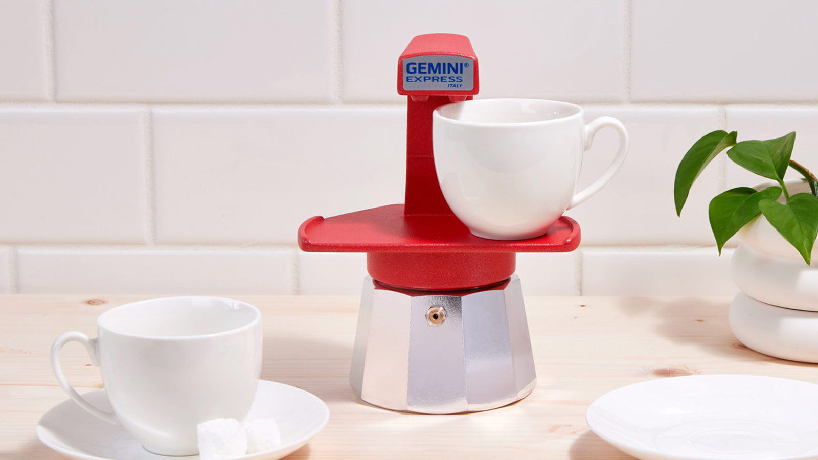 Red Gemini stovetop espresso maker brewing directly into a cup for Best Coffee Gifts for 2025.