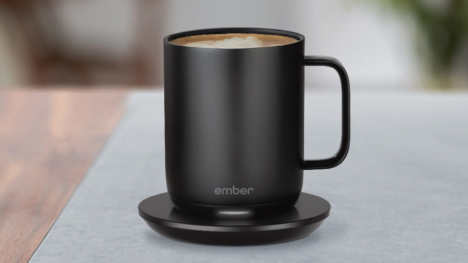 Black Ember Mug warming a latte on its charging base for Best Coffee Gifts for 2025.