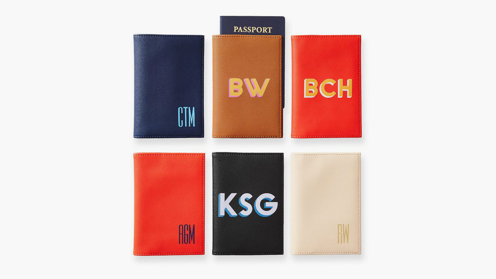 Mark & Graham Fillmore Passport Cases in multiple colors with monograms, a personalized pick among the best travel gifts.