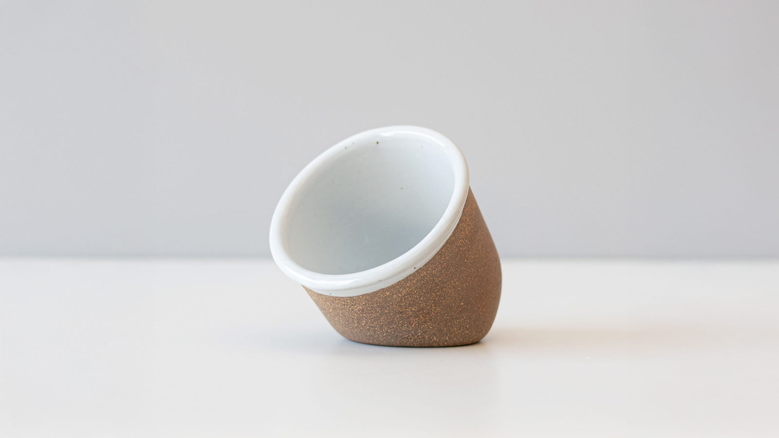 Handmade ceramic salt cellar with angled opening, a functional countertop upgrade for home chefs.