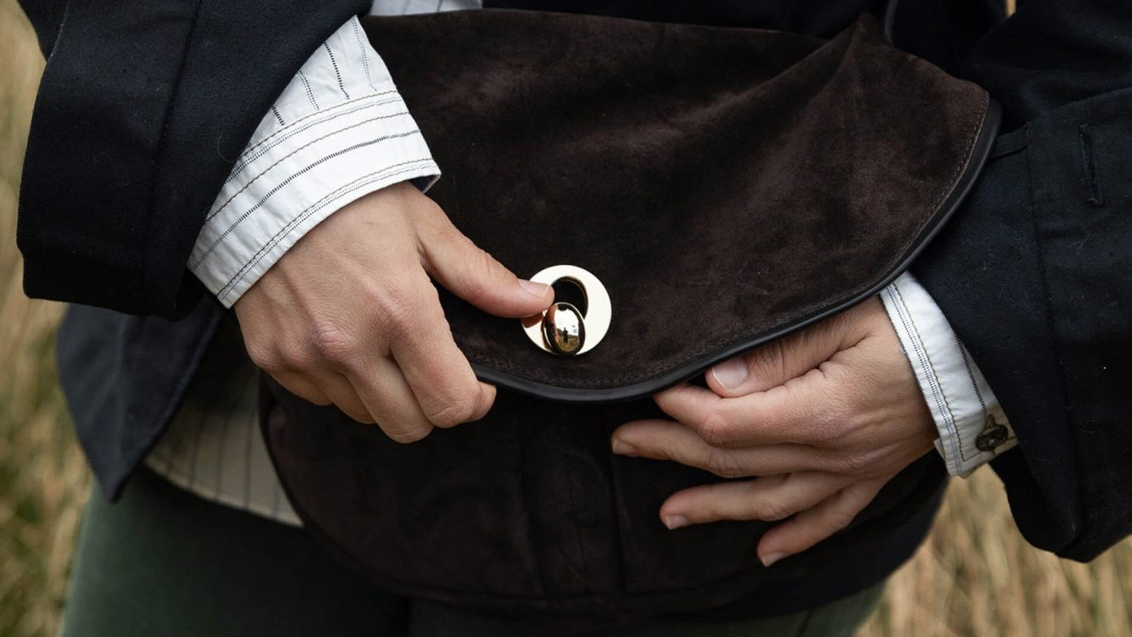 Dark brown suede shoulder bag with gold hardware, a luxurious accessory from the best holiday gifts for women