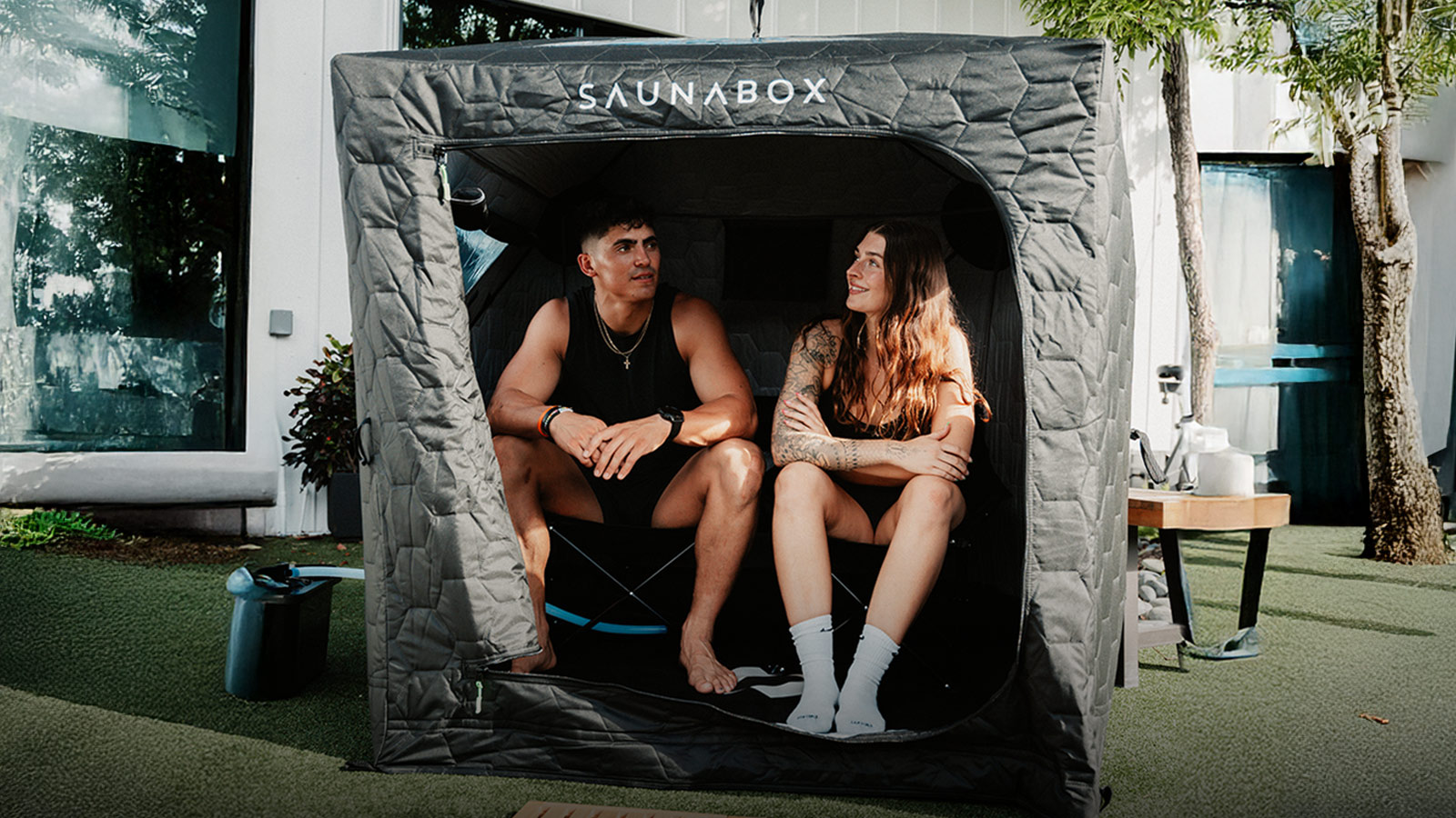 Portable SaunaBox Go with two people inside, among the best wellness gifts for recovery and relaxation at home