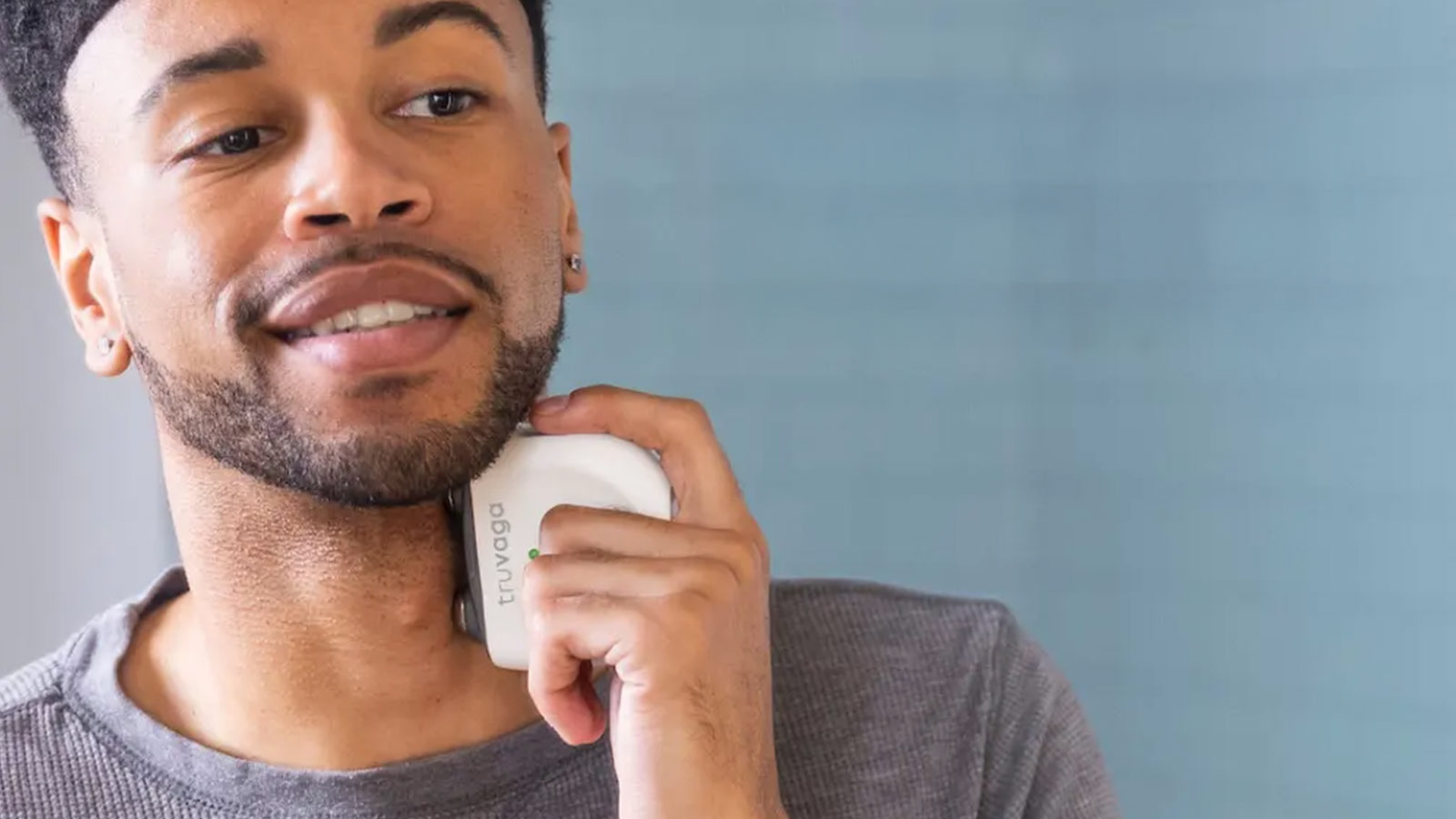 Man using Truvaga Plus neck device, a cutting-edge wellness gadget and one of the best wellness gifts for nervous system care