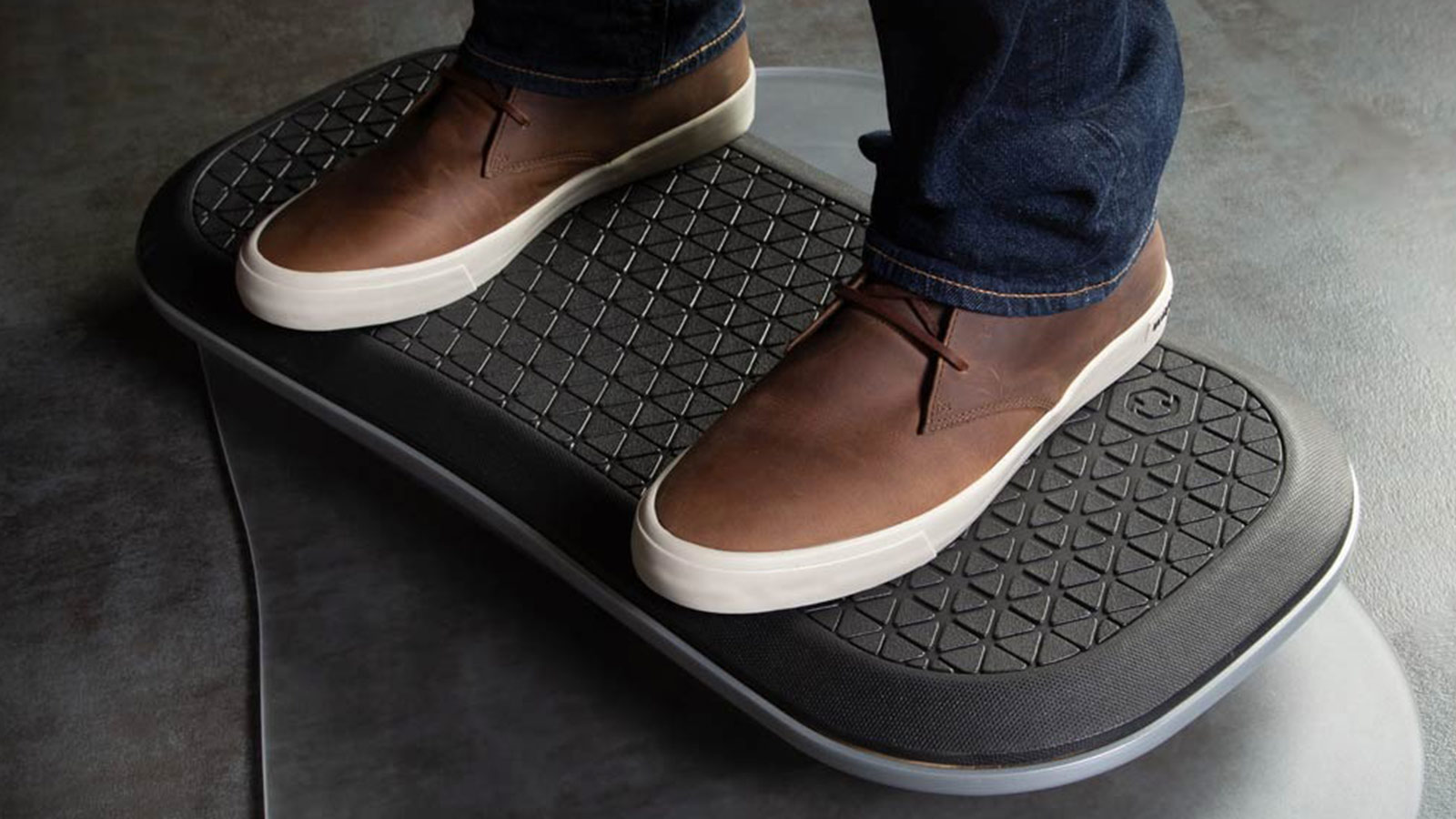 Close-up of FluidStance balance board at a standing desk, one of the best wellness gifts for movement throughout the workday