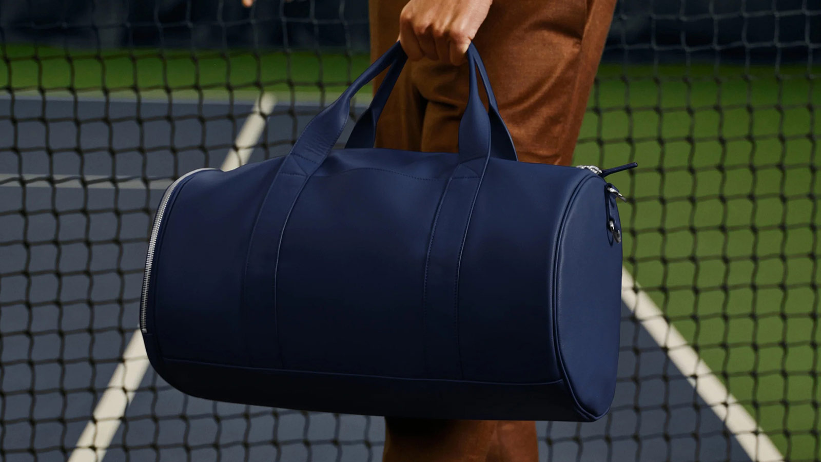 Navy Leatherology Barrel Gym Bag on the ground, one of the best wellness gifts for stylish and functional fitness routines