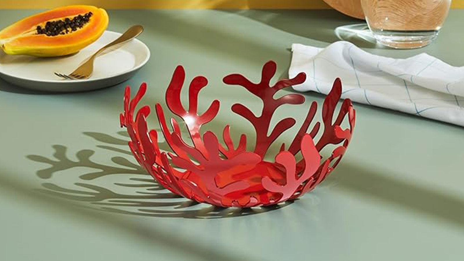 Red coral‑inspired Alessi fruit bowl with sculptural openwork design — an artistic gift for design lovers.