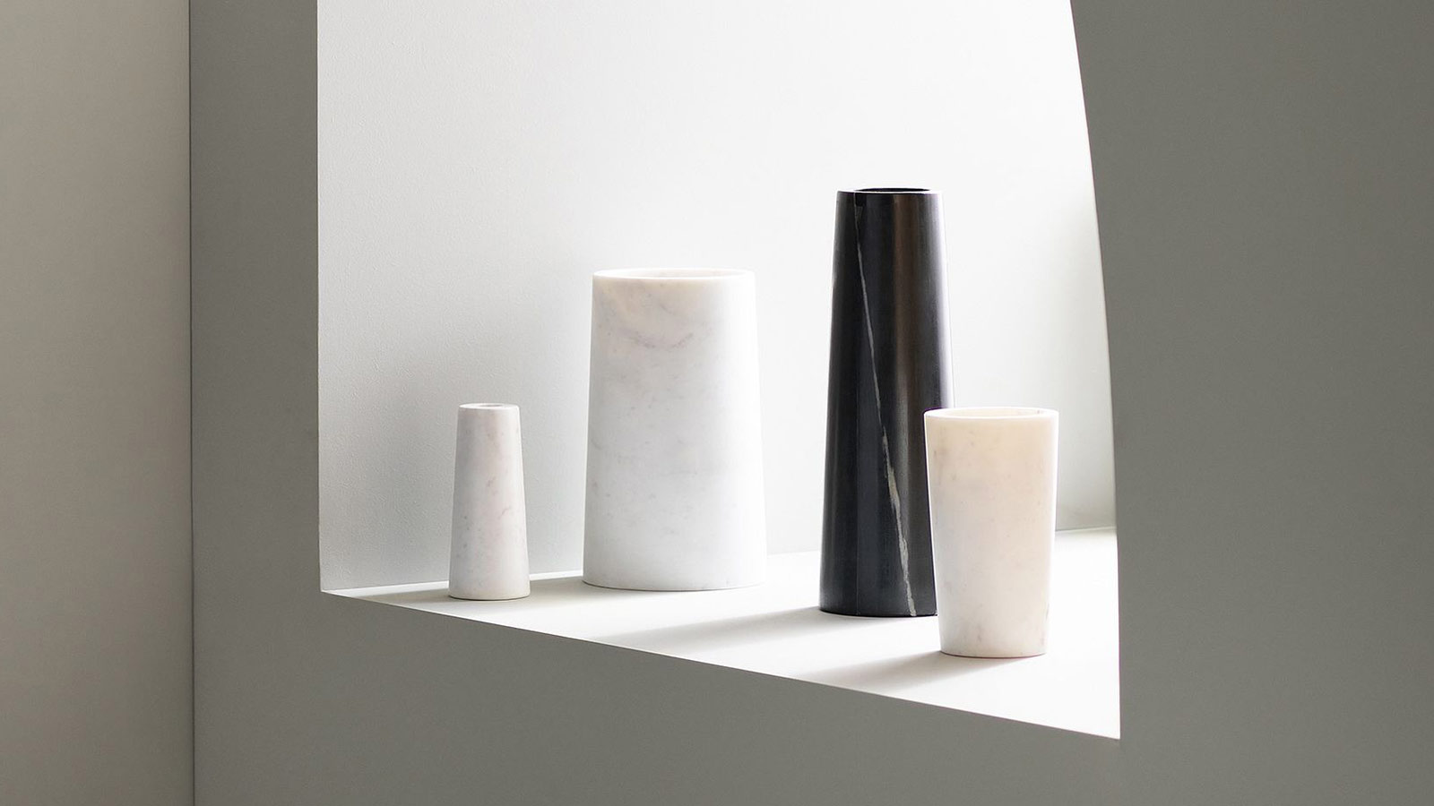 Minimal marble cylinder vases in black and white tones — timeless sculptural gifts for design lovers.