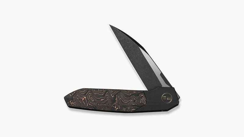 The WEKNIFE Brr15 has a rugged black titanium frame inlaid with copper foil.