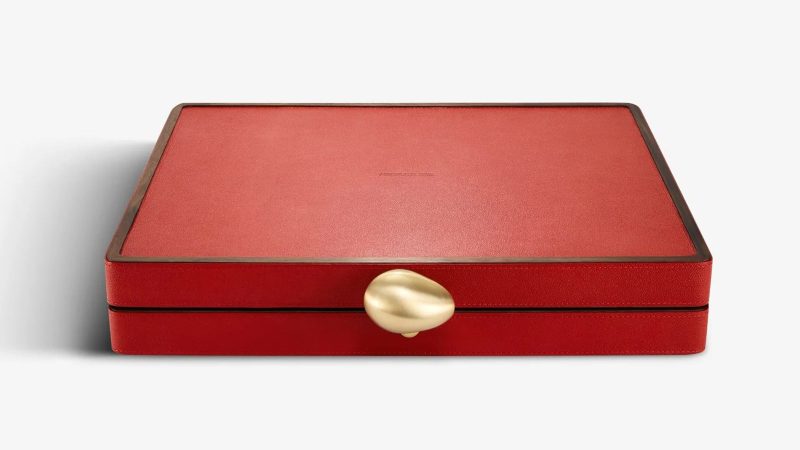 Assouline's Library Collection Backgammon Set features a luxurious walnut wood case and a multi-colored pebbled leather inlaid board.