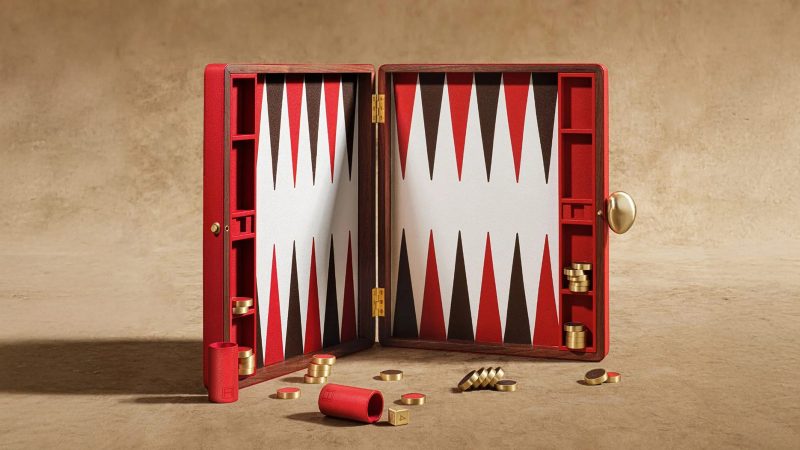 Assouline's Library Collection Backgammon Set features a luxurious walnut wood case and a multi-colored pebbled leather inlaid board.