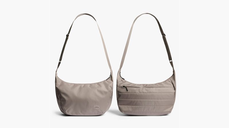 Bellroy’s Laneway Crescent Bag is a recycled nylon cross-body sling design featuring a wide-mouth zipper, internal tool belt pocket, quilted back panel, adjustable webbing strap, and AirTag sleeve.