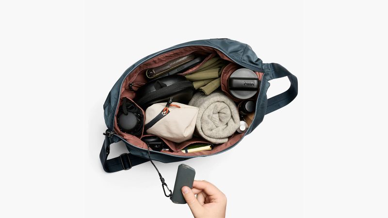 Bellroy’s Laneway Crescent Bag is a recycled nylon cross-body sling design featuring a wide-mouth zipper, internal tool belt pocket, quilted back panel, adjustable webbing strap, and AirTag sleeve.