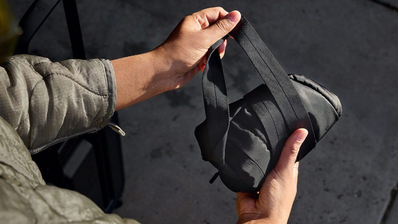 Bellroy’s Laneway Crescent Bag is a recycled nylon cross-body sling design featuring a wide-mouth zipper, internal tool belt pocket, quilted back panel, adjustable webbing strap, and AirTag sleeve.