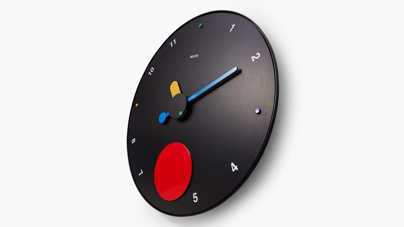 MoMA Exclusive Contrattempo Wall Clock with bold red swinging disc, inspired by Memphis Design, crafted from recycled ABS and aluminum.