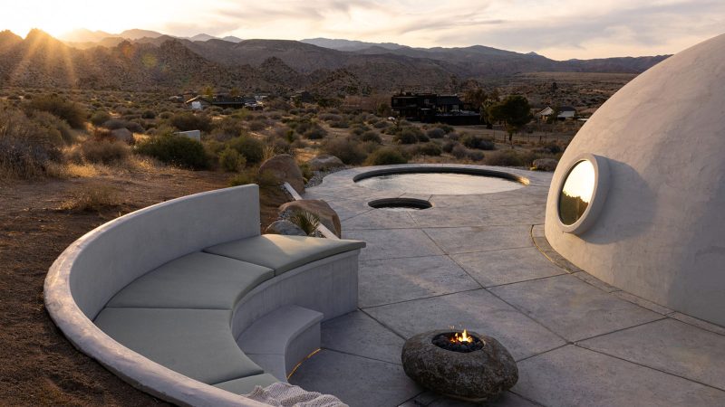 Sculptural concrete dome house in California’s High Desert, designed by Anastasiya Dudik, with curved monolithic exterior, saltwater pool, and minimalist brutalist interior built from concrete, stone, and plaster.