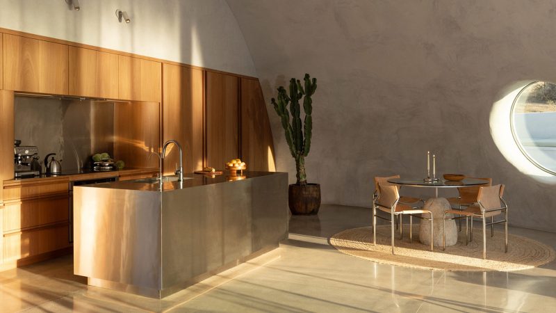 Sculptural concrete dome house in California’s High Desert, designed by Anastasiya Dudik, with curved monolithic exterior, saltwater pool, and minimalist brutalist interior built from concrete, stone, and plaster.