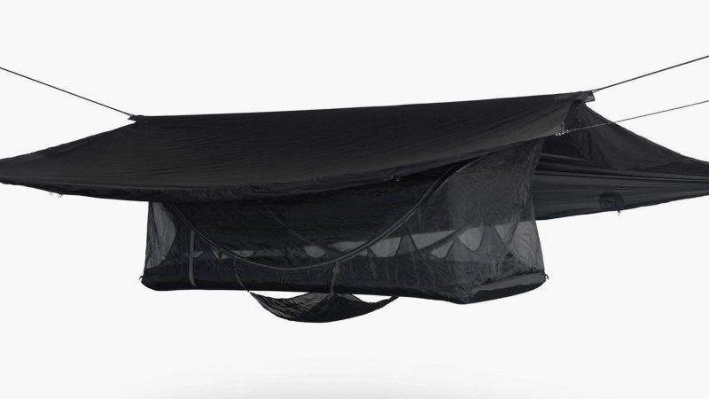 Haven Spectre ultralight lay-flat hammock tent suspended between trees, featuring carbon spreader bars, inflatable mattress, Monolite mesh, and compact setup.