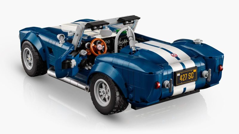 LEGO's Icons Shelby Cobra 427 S/C model car kit for adults features a blue body, white racing stripes, and a detailed V8 engine.