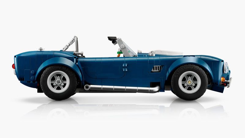LEGO's Icons Shelby Cobra 427 S/C model car kit for adults features a blue body, white racing stripes, and a detailed V8 engine.