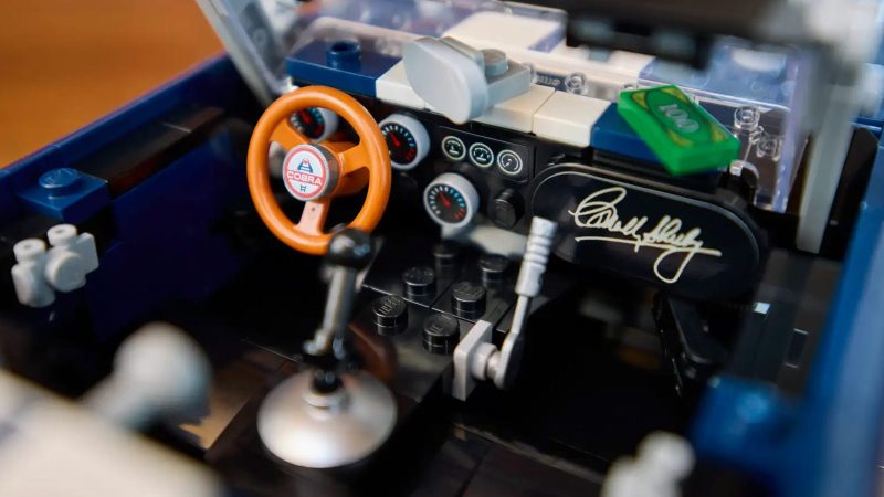 LEGO's Icons Shelby Cobra 427 S/C model car kit for adults features a blue body, white racing stripes, and a detailed V8 engine.