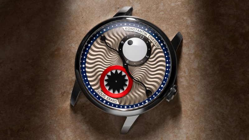 The Louis Erard x Konstantin Chaykin Time Eater III watch features a cyclops eye hour disc, a teethy seconds subdial, a devil-horned minute hand, a polished steel case, and an enamel Regulator layout.