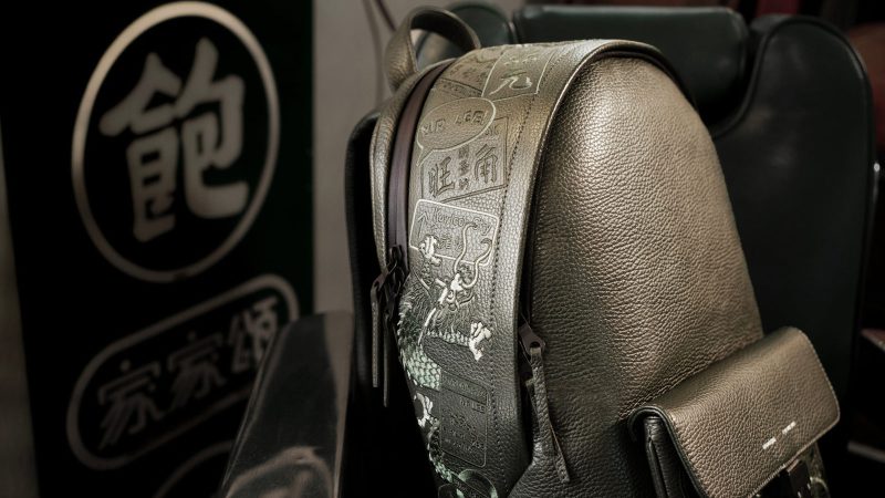MR LEE x GRAMS28 stealth black leather backpack with tone-on-tone Hong Kong–London embroidered design.