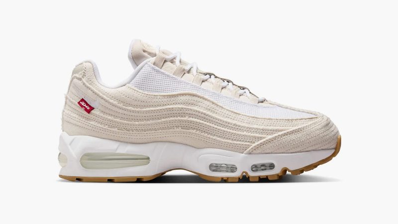 Levi’s x Nike Air Max 95 sneakers in denim with frayed edges, co-branded red accents, and matching relaxed jeans and denim jacket from the collection.