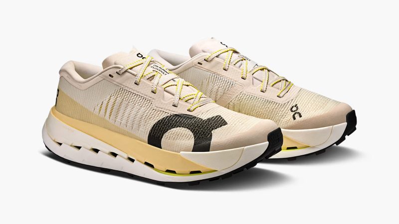The On Cloudultra Pro trail running shoe features a rugged outsole, a carbon-infused speedboard, and a breathable mesh upper designed for ultra-distance performance.
