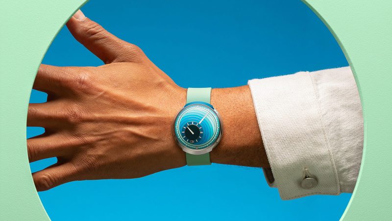 Ressence Type 8 DE1 & DE2 Art Watches — pebble-shaped grade 5 titanium cases with sculptural gradient “Inside Out” dials in pink (DE1) and turquoise (DE2) rubber straps.