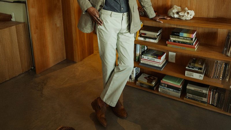 Lightweight khaki chinos styled indoors—transitional essentials for versatile summer outfits.