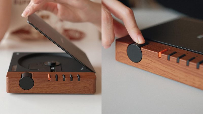 The Syitren R300 CD Player boasts a matte black design with a wood-paneled control zone, a transparent disc lid, a tactile volume knob, Bluetooth, AUX, optical output, and a USB-C power port.