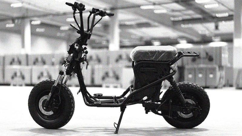 Teenage Engineering x Vässla EPA‑1 electric moped in matte black with modular front rack and screw‑mount accessory points.
