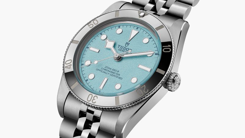 Tudor's Black Bay 54 Lagoon Blue dive watch boasts a 37mm stainless steel case, sand-textured blue dial, and a five-link bracelet.