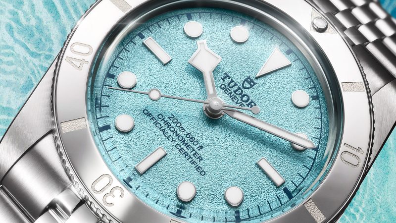 Tudor's Black Bay 54 Lagoon Blue dive watch boasts a 37mm stainless steel case, sand-textured blue dial, and a five-link bracelet.