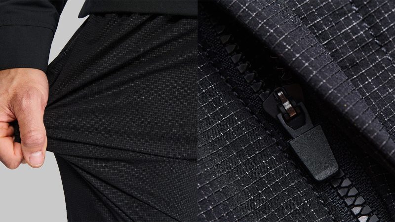 Vollebak Ultra High Molecular Weight Pants in black with ripstop UHMWPE grid, water-repellent finish, and concealed zip pockets.
