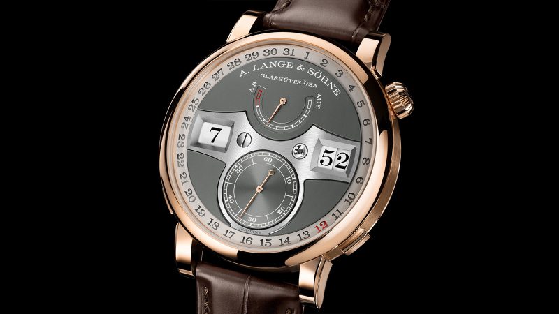 A. Lange & Söhne Zeitwerk Date in 18k pink gold with slate-gray dial, features a digital time display, outer date ring, and in-house calibre L043.8 movement visible through a sapphire caseback.