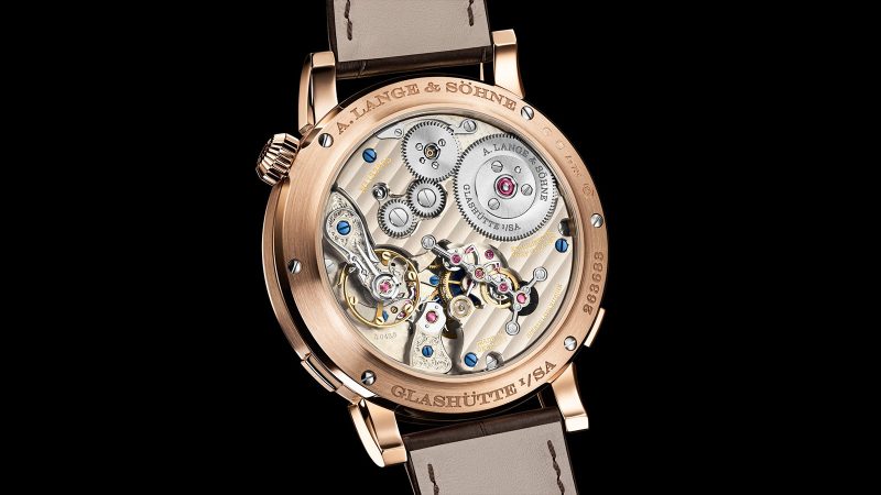 A. Lange & Söhne Zeitwerk Date in 18k pink gold with slate-gray dial, features a digital time display, outer date ring, and in-house calibre L043.8 movement visible through a sapphire caseback.