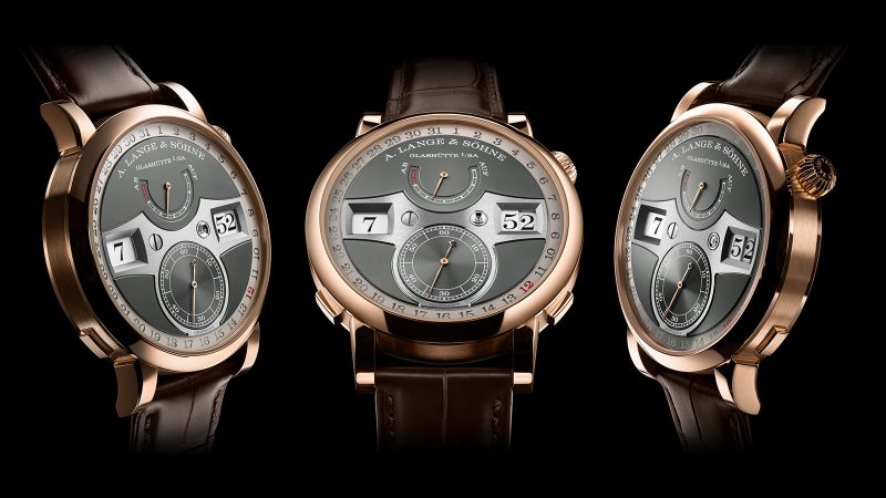 A. Lange & Söhne Zeitwerk Date in 18k pink gold with slate-gray dial, features a digital time display, outer date ring, and in-house calibre L043.8 movement visible through a sapphire caseback.
