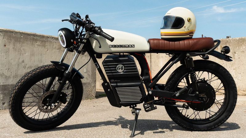 The Beachman ’64 e-bike captures the spirit of a classic Café Racer with a sleek electric drivetrain, offering up to 70 miles of range and vintage-inspired style.