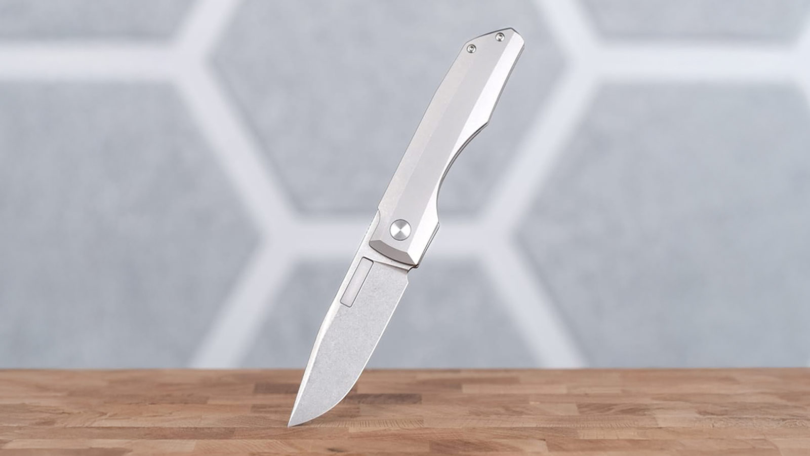 Minimalist titanium folding knife with sleek silhouette, one of the Best EDC Knives for Men 2025.