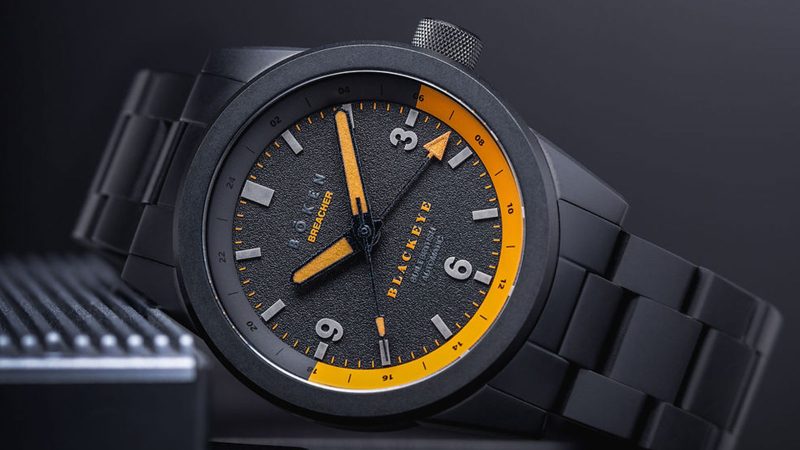 Bōken x Blackeye Phantom Breacher GMT watch featuring a black DLC-coated case, Swiss Sellita movement, orange lume, and a limited run of 42 pieces for a rugby charity.