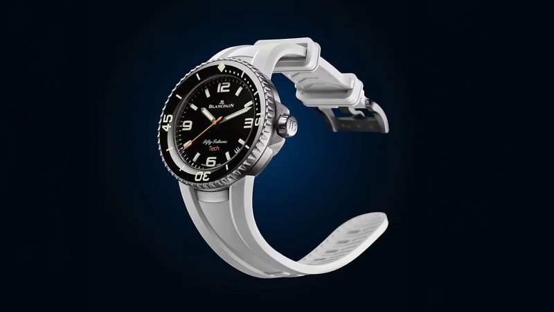 Blancpain Fifty Fathoms Tech 5029 dive watch with brushed titanium case, black dial, ceramic bezel, and bold orange rubber strap—combining professional diving specs with refined lifestyle appeal.