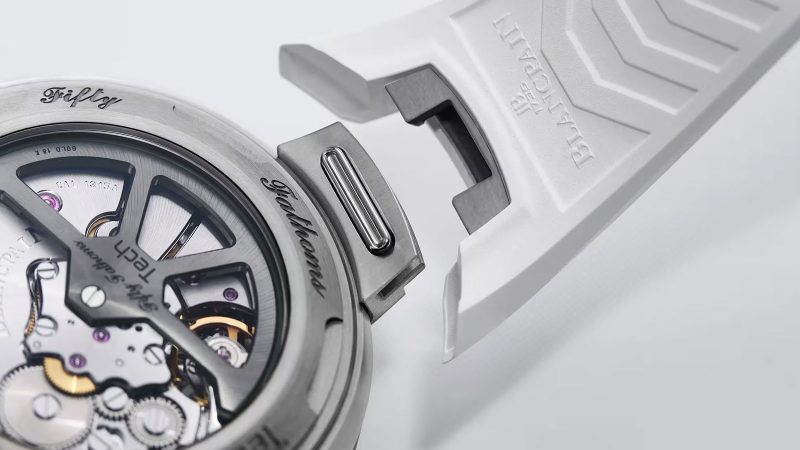 Blancpain Fifty Fathoms Tech 5029 dive watch with brushed titanium case, black dial, ceramic bezel, and bold orange rubber strap—combining professional diving specs with refined lifestyle appeal.