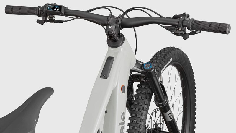 Cannondale Moterra 3 electric mountain bike with Bosch CX motor, 800Wh battery, and RockShox suspension on rugged forest trail.