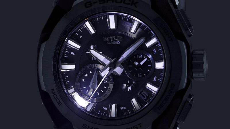 Casio MT‑G B4000 blue‑gray watch showcasing a layered carbon‑fiber case, stainless steel bezel, rugged Dual Core Guard structure, and tech controls.