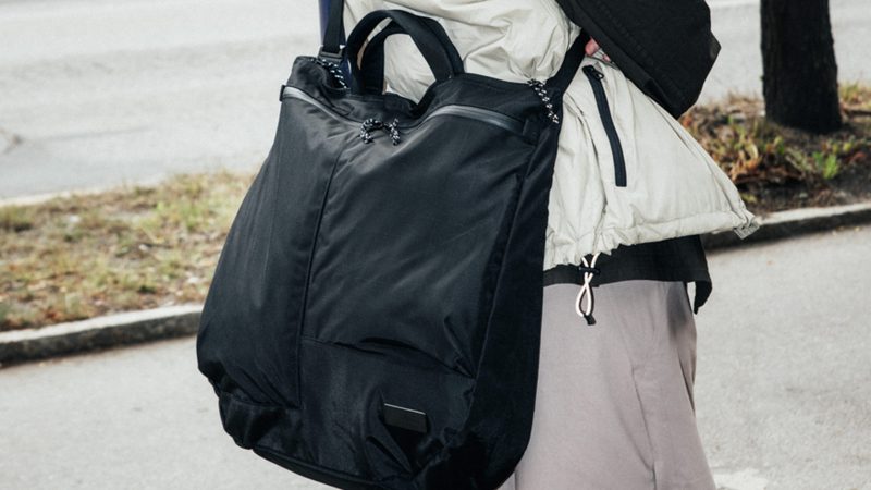 D_B_ Utility Tote 32L with recycled materials, front zip pockets, laptop sleeve, and adjustable strap for commuting, travel, and cycling use.