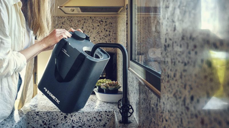 Dometic GO Hydration Faucet dispenses water, showcasing its sleek self‑powered tap for outdoor adventures.
