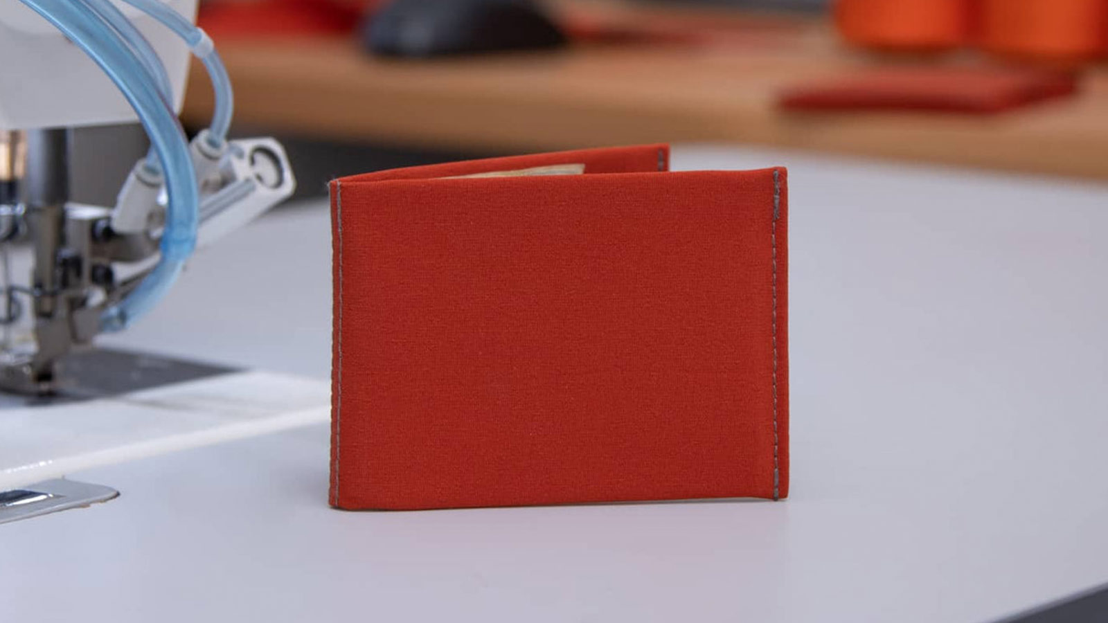 Bright red stitched fabric wallet—eco-forward and bold for best minimalist wallets for men 2025.